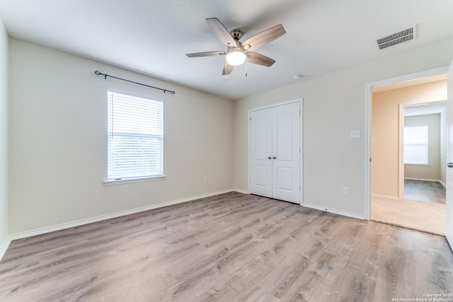 129 Sandy Shl, Boerne, TX 78006 - unfurnished bedroom featuring wood finished floors, a closet, and ceiling fan