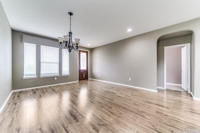 129 Sandy Shl, Boerne, TX 78006 - spare room featuring light wood finished floors, arched walkways, a chandelier, and recessed lighting