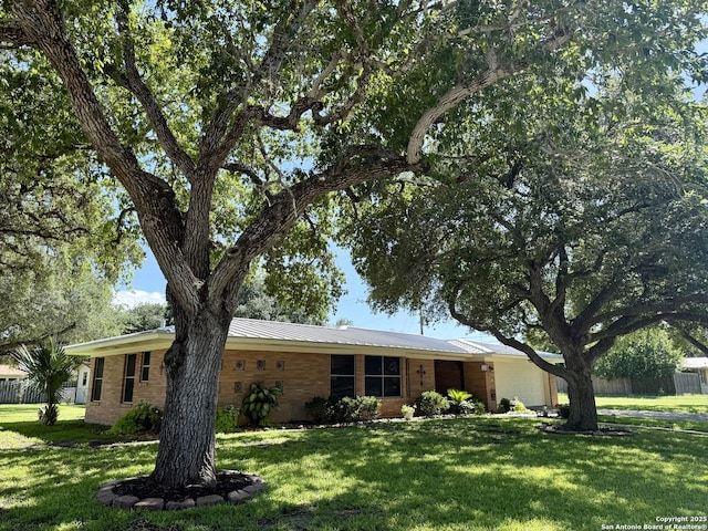 803 Leland, Kenedy, TX 78119 - ranch-style home with a garage and brick siding
