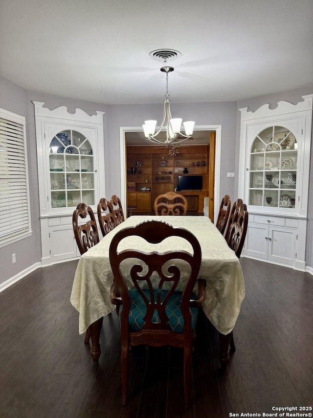 803 Leland, Kenedy, TX 78119 - dining space featuring a chandelier and dark wood-style flooring