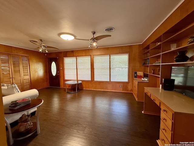 803 Leland, Kenedy, TX 78119 - living room with ceiling fan, an office area, dark wood-style flooring, wood walls, and crown molding