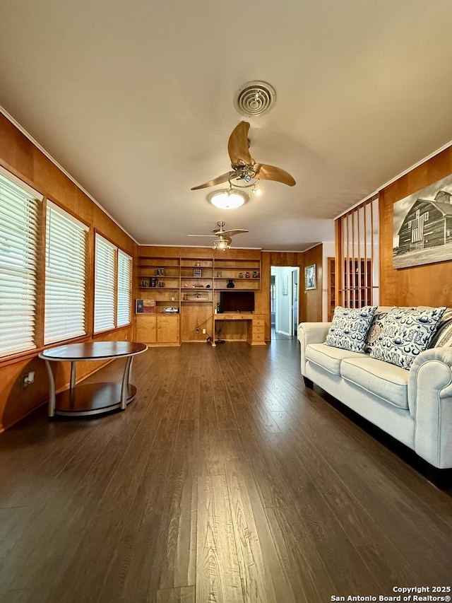 803 Leland, Kenedy, TX 78119 - living room with ceiling fan, dark wood finished floors, and wooden walls