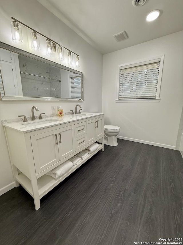 803 Leland, Kenedy, TX 78119 - full bathroom with double vanity, a marble finish shower, and wood finished floors