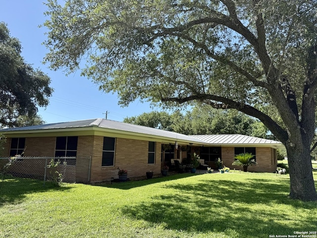 803 Leland, Kenedy, TX 78119 - rear view of property with a standing seam roof, brick siding, and a metal roof