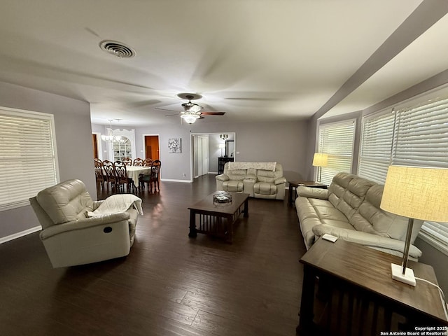 803 Leland, Kenedy, TX 78119 - living room featuring dark wood-style floors, a ceiling fan, and a chandelier