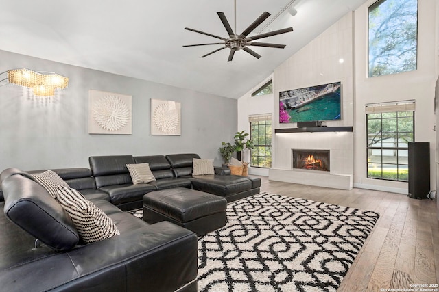 2915 Quail Oak, San Antonio, TX 78232 - living room with high vaulted ceiling, a ceiling fan, wood finished floors, a large fireplace, and plenty of natural light