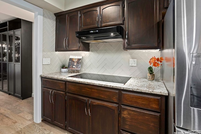 2915 Quail Oak, San Antonio, TX 78232 - kitchen with stainless steel refrigerator with ice dispenser, under cabinet range hood, black electric stovetop, tasteful backsplash, and dark brown cabinetry