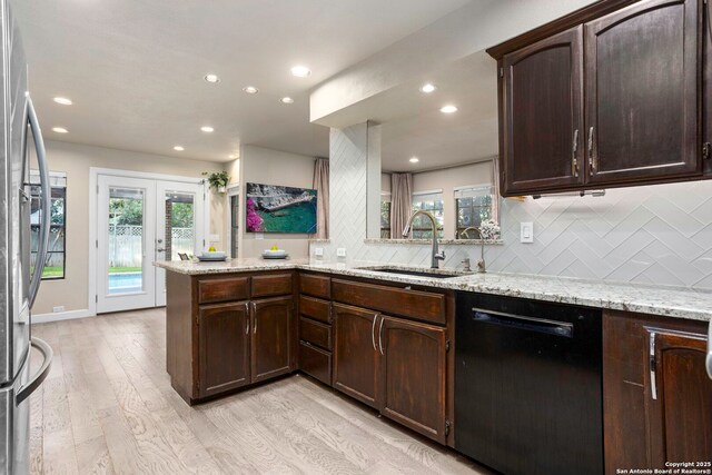 2915 Quail Oak, San Antonio, TX 78232 - kitchen featuring black dishwasher, light wood-style flooring, recessed lighting, backsplash, and freestanding refrigerator
