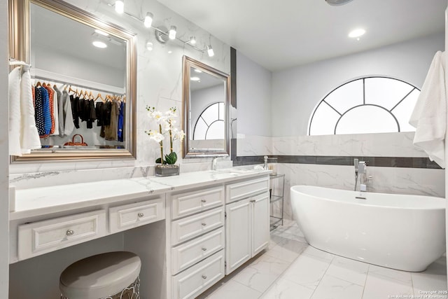 2915 Quail Oak, San Antonio, TX 78232 - full bathroom with tile walls, double vanity, marble finish floors, a soaking tub, and recessed lighting