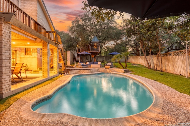 2915 Quail Oak, San Antonio, TX 78232 - pool at dusk with an outdoor hangout area, a fenced backyard, stairs, and a patio area