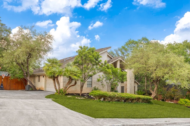 2915 Quail Oak, San Antonio, TX 78232 - obstructed view of property featuring concrete driveway, a garage, a front yard, and brick siding