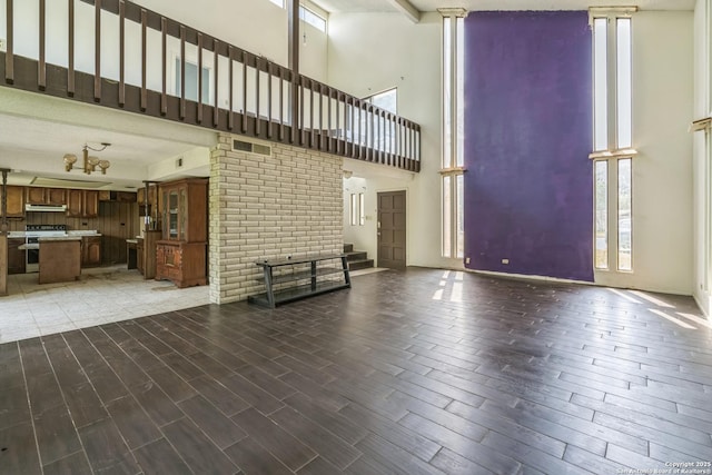 6231 Little Fawn, San Antonio, TX 78238 - unfurnished living room with a towering ceiling and wood finished floors