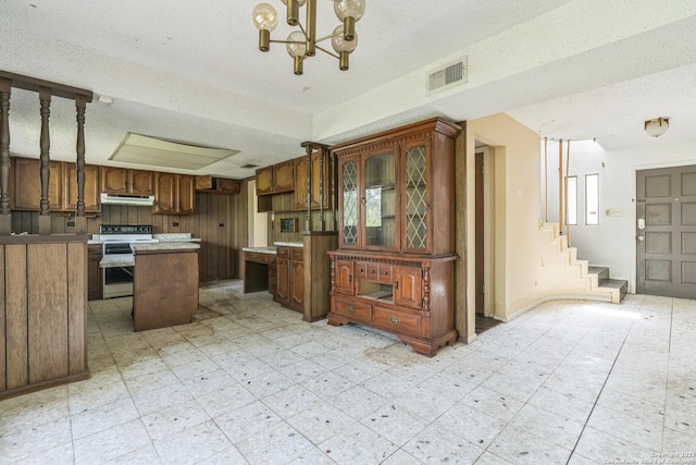 6231 Little Fawn, San Antonio, TX 78238 - kitchen featuring electric stove, a textured ceiling, under cabinet range hood, a center island, and a chandelier