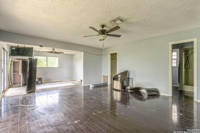6231 Little Fawn, San Antonio, TX 78238 - unfurnished living room featuring ceiling fan, wood finished floors, and a textured ceiling
