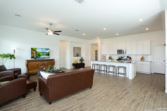 5798 Luciano Trl, Seguin, TX 78155 - living room featuring light wood-style flooring, a ceiling fan, and recessed lighting