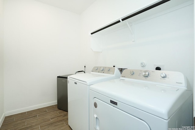 5798 Luciano Trl, Seguin, TX 78155 - laundry area featuring washing machine and dryer and wood finished floors