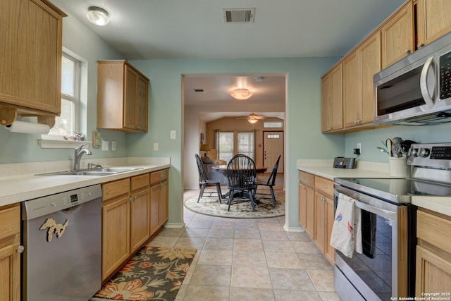 8822 Fernbrook, San Antonio, TX 78250 - kitchen with stainless steel appliances, a ceiling fan, and light countertops