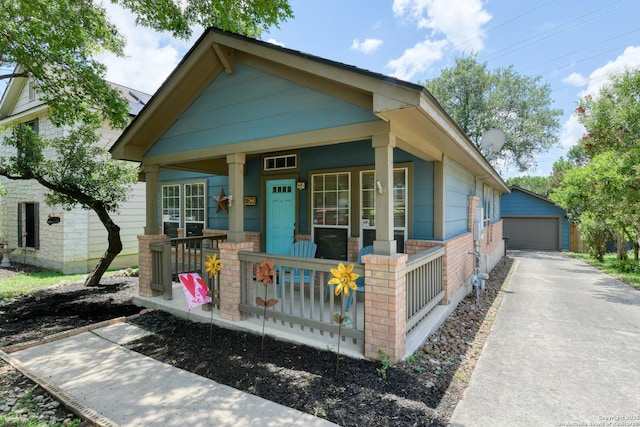 8822 Fernbrook, San Antonio, TX 78250 - shotgun-style home with covered porch, a detached garage, and an outbuilding
