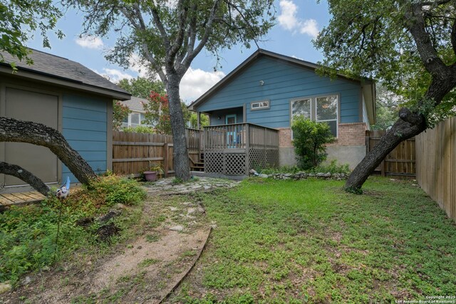 8822 Fernbrook, San Antonio, TX 78250 - rear view of house with a fenced backyard, brick siding, and a deck