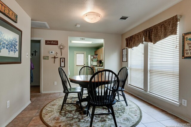 8822 Fernbrook, San Antonio, TX 78250 - dining area with baseboards and light tile patterned floors