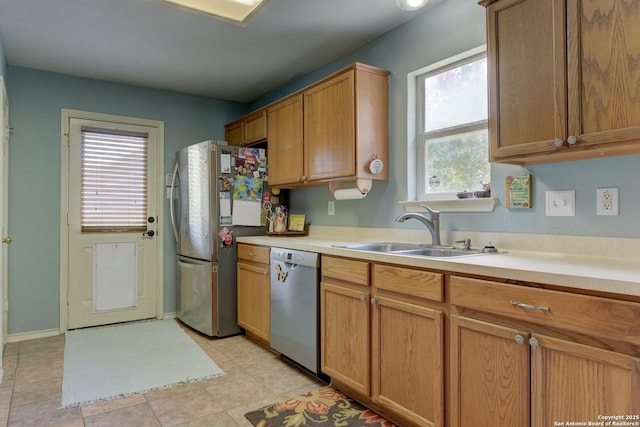 8822 Fernbrook, San Antonio, TX 78250 - kitchen featuring appliances with stainless steel finishes, light countertops, light tile patterned floors, and brown cabinets