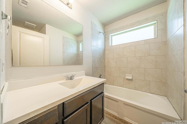 7119 Magnolia Blf, San Antonio, TX 78218 - full bath featuring vanity, shower / bath combination, and wood finished floors
