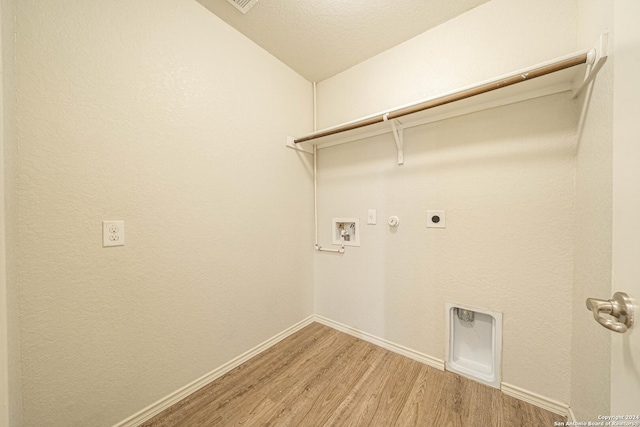 7119 Magnolia Blf, San Antonio, TX 78218 - laundry area featuring hookup for an electric dryer, gas dryer hookup, light wood-type flooring, and washer hookup