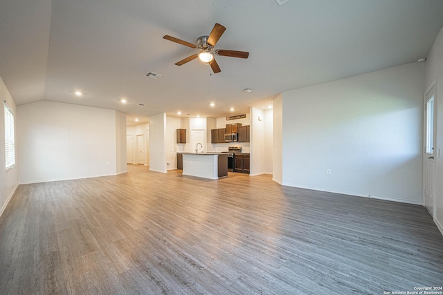 7119 Magnolia Blf, San Antonio, TX 78218 - unfurnished living room featuring a ceiling fan, light wood-style flooring, recessed lighting, and vaulted ceiling