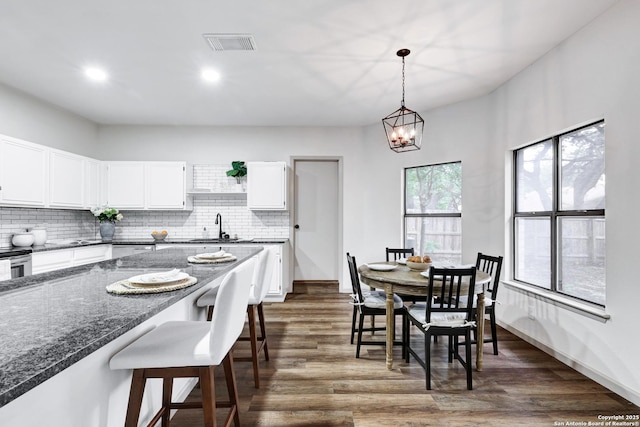 13322 Galicia, Universal City, TX 78148 - dining area featuring dark wood finished floors, recessed lighting, and a chandelier