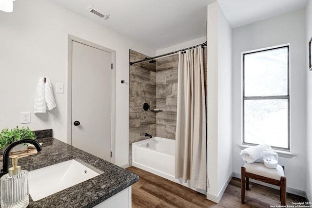 13322 Galicia, Universal City, TX 78148 - full bathroom with vanity, wood finished floors, healthy amount of natural light, and shower / tub combo with curtain
