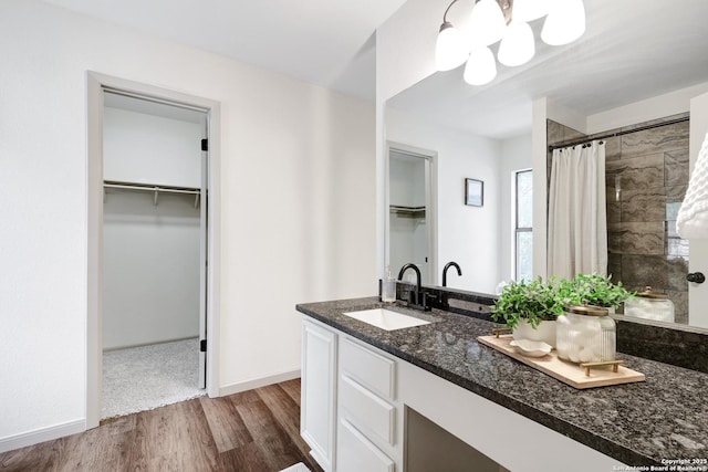 13322 Galicia, Universal City, TX 78148 - bathroom with wood finished floors, a spacious closet, vanity, and tiled shower