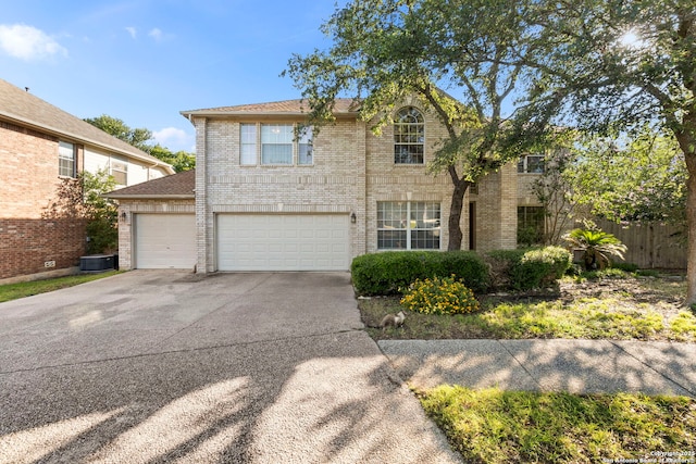 2611 Menard, San Antonio, TX 78251 - traditional-style house with driveway, brick siding, and a garage
