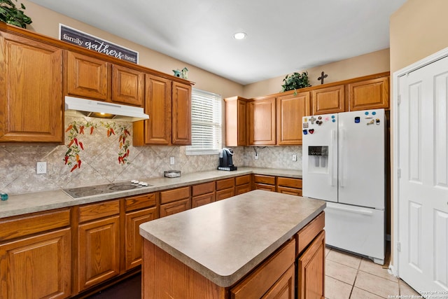 2611 Menard, San Antonio, TX 78251 - kitchen with white fridge with ice dispenser, black electric stovetop, under cabinet range hood, brown cabinets, and tasteful backsplash