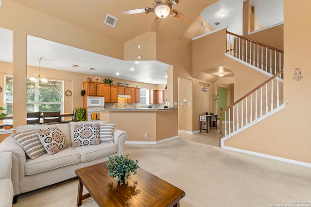2611 Menard, San Antonio, TX 78251 - living area featuring a ceiling fan, a chandelier, stairs, light colored carpet, and plenty of natural light