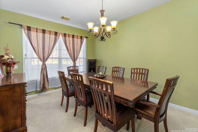 2611 Menard, San Antonio, TX 78251 - dining area featuring a chandelier and light colored carpet