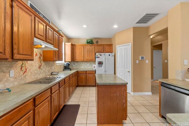 2611 Menard, San Antonio, TX 78251 - kitchen featuring white fridge with ice dispenser, dishwasher, under cabinet range hood, electric cooktop, and a center island