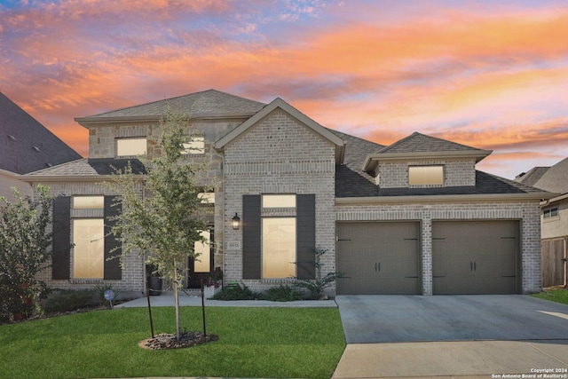 9032 Raven Pointe, San Antonio, TX 78255 - french country style house with a garage, a yard, brick siding, concrete driveway, and a shingled roof