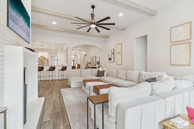 9032 Raven Pointe, San Antonio, TX 78255 - living room with arched walkways, beamed ceiling, ceiling fan, wood finish floors, and recessed lighting