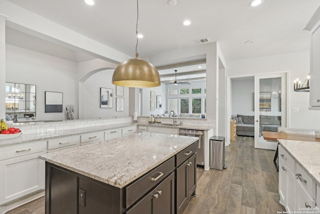 9032 Raven Pointe, San Antonio, TX 78255 - kitchen with dishwasher, recessed lighting, white cabinetry, dark brown cabinetry, and backsplash