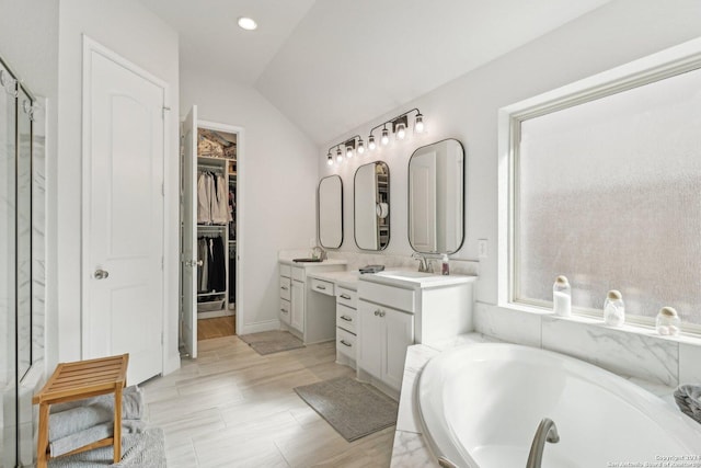 9032 Raven Pointe, San Antonio, TX 78255 - full bath with vanity, a garden tub, vaulted ceiling, and a walk in closet