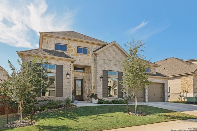 9032 Raven Pointe, San Antonio, TX 78255 - french country style house with concrete driveway, a front yard, a garage, and stone siding