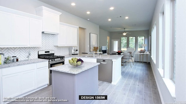 225 Alpine Lks, New Braunfels, TX 78130 - kitchen featuring appliances with stainless steel finishes, a peninsula, decorative backsplash, a center island, and ceiling fan