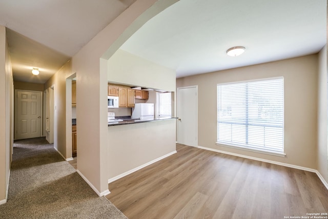 7334 Cherry Brk, San Antonio, TX 78238 - kitchen with white appliances, dark countertops, light wood-style floors, and light brown cabinetry