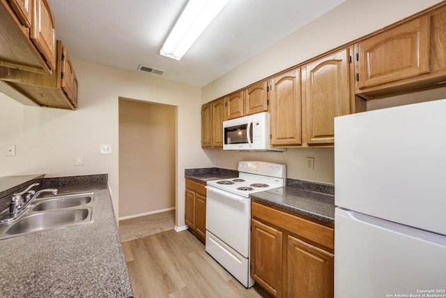 7334 Cherry Brk, San Antonio, TX 78238 - kitchen with white appliances, light wood-style floors, and dark countertops