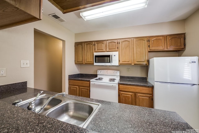 7334 Cherry Brk, San Antonio, TX 78238 - kitchen featuring white appliances, dark countertops, and brown cabinets