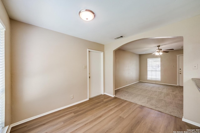 7334 Cherry Brk, San Antonio, TX 78238 - unfurnished room featuring arched walkways, ceiling fan, and light wood-style floors