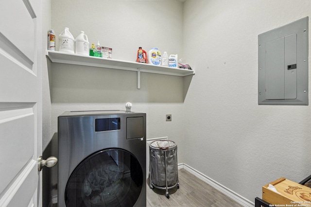 12108 Buckaroo Rnch, San Antonio, TX 78254 - laundry area featuring washer / dryer, electric panel, and wood finished floors