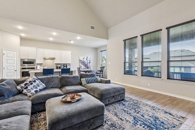 12108 Buckaroo Rnch, San Antonio, TX 78254 - living area featuring wood finished floors, vaulted ceiling, and recessed lighting