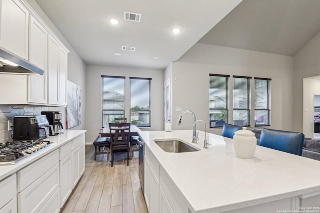 12108 Buckaroo Rnch, San Antonio, TX 78254 - kitchen featuring stainless steel appliances, custom range hood, a center island with sink, light wood finished floors, and recessed lighting