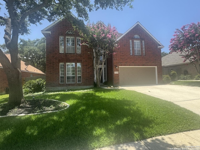 21539 Bubbling Crk, San Antonio, TX 78259 - traditional home with an attached garage, concrete driveway, brick siding, and a front yard